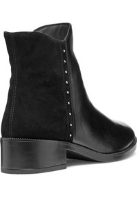 Black leather ankle boot featuring a smooth finish, rounded toe, subtle stud accents along the side, and a sturdy block heel.