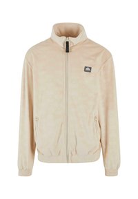 Vaalean beige vetoketjullinen takki, jossa on korkea kaulus, hienovarainen kuvio, joustavat hihansuut ja etupuolella logo-ompelu. Pehmeä, sileä kangas.