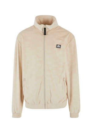 Light beige zip-up jacket with a high collar, featuring a subtle pattern, elastic cuffs, and a front logo patch. Soft, smooth fabric.