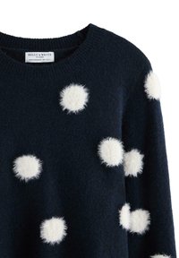 Maglione blu navy in morbida lana, con pois bianchi soffici su tutta la parte anteriore e scollo tondo.