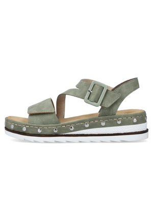 Green suede sandal with adjustable straps, buckle closure, and white rubber sole featuring silver studs along the edge.