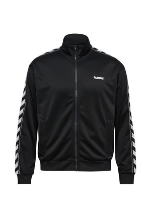Zwart trainingsjack met ritssluiting, witte chevronstrepen langs de mouwen en een klein wit "hummel" logo op de linkerbovenborst.