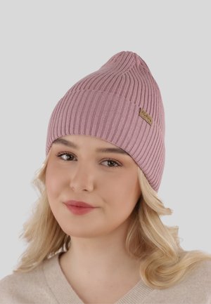Pink ribbed knit beanie with a pointed top and a leather logo patch. Soft texture, fitted design, suitable for cold weather.