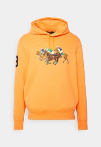 Orange hoodie made of cotton, featuring a graphic of three polo players on horseback. Includes a drawstring hood and ribbed cuffs.