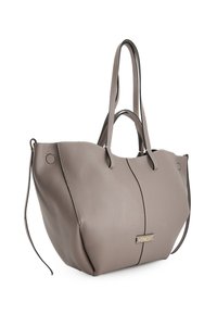 Torebka tote w kolorze taupe z podwójnymi uchwytami, gładką teksturą, bocznymi paskami oraz złotą plakietką z logo "Venezia" na przednim środku.