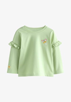 Šviesiai žalia ilgomis rankovėmis marškinėliai su volanėmis. Papuošti siuvinėtomis drugelių ir gėlių detalėmis. Minkšta medvilninė medžiaga.