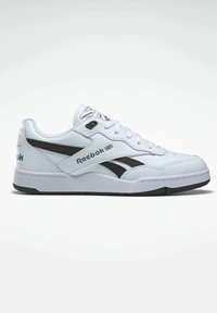 White Reebok sneakers with a black accent, featuring a smooth leather upper, round toe, lace closure, and textured rubber sole.