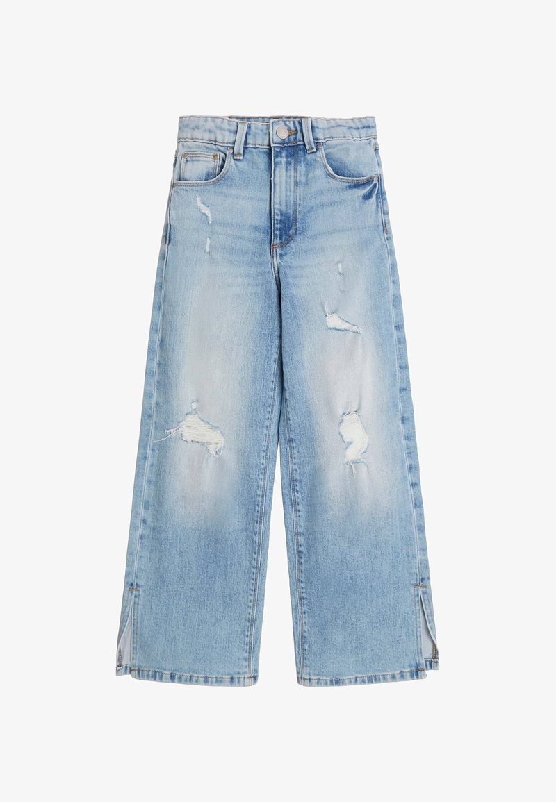 Vaaleansiniset leveälahkeiset farkut denimiä, joissa on kulutusta ja raakoja helmoja. Sivuhalkiot lahkeiden alareunassa korostavat mallia.