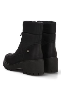 Botines negros con parte superior de tela acolchada, acentos de cuero, detalle de cremallera y suela de goma texturizada con una ligera plataforma.