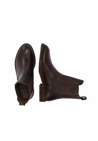 Bottines en cuir marron avec des panneaux élastiques latéraux, bout rond, détails cousus et petit talon. Comprend une languette à l'arrière pour un enfilage facile.