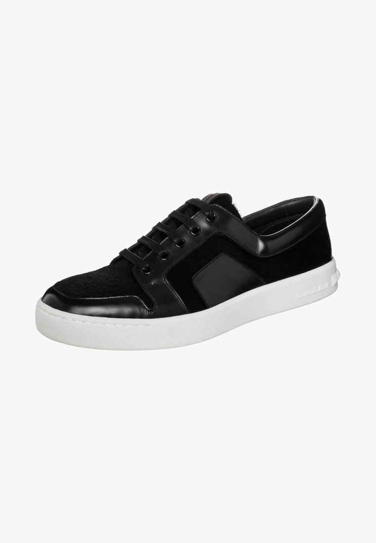 Black sneaker with a smooth leather and textured upper, featuring a white rubber sole, round laces, and a side logo detail.