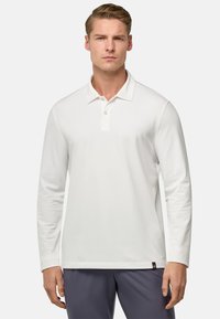Maglietta polo bianca a maniche lunghe con colletto, patta con due bottoni e una piccola etichetta del marchio sull'orlo. Tessuto liscio e design aderente.