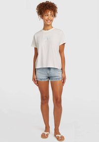 White short-sleeve t-shirt with a round neckline, paired with light blue denim shorts. Features a relaxed fit and soft texture.