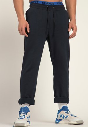 Donkerblauwe joggingbroek gemaakt van zachte stof, met een elastische tailleband met blauwe accenten, opgerolde manchetten en een ontspannen pasvorm.