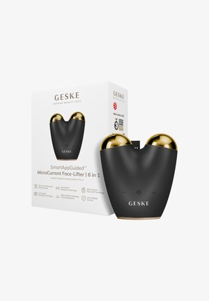 GESKE MicroCurrent Face-Lifter-enhed med sort krop og gyldne kugler, vist ved siden af sin emballage, der viser produktegenskaber og priser.
