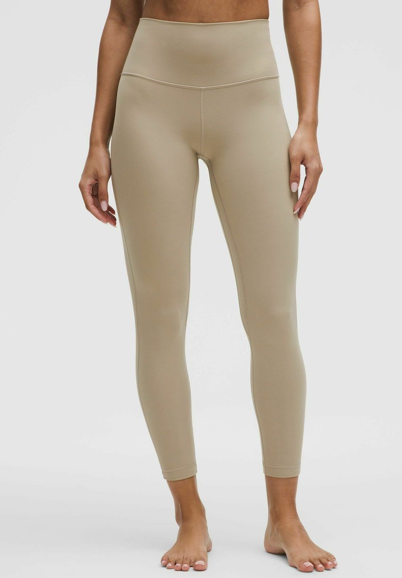 Nahé legíny s vysokým pásom vyrobené z hladkého a elastického materiálu, s jednoduchým dizajnom a priliehavým strihom.