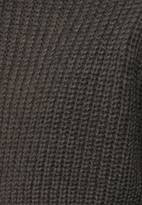 Dark gray knitted fabric with a ribbed texture, featuring prominent horizontal and vertical lines, indicating a thick and warm material.