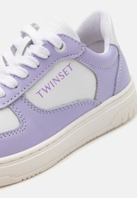 Lavender and white sneakers with leather upper, lace closure, and rubber sole. Features purple "TWINESET" branding and stitched accents.