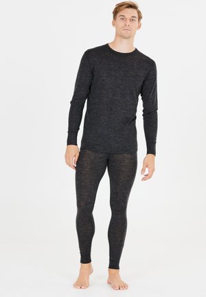 Schwarzes Langarmshirt und Leggings-Set aus einem weichen, strukturierten Stoff. Enganliegendes Design mit minimalen Nähten, beide zeigen ein meliertes Muster.