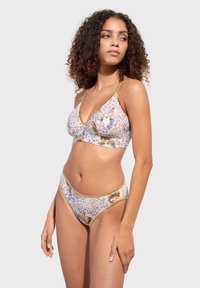 Floral print bikini with purple leopard pattern. The top features a triangular design, while the bottoms have a low-rise cut. Gold accents.