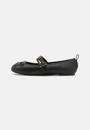 Black leather ballet flat with two decorative straps, round toe, small heel, and a looped detail at the front. Smooth texture throughout.