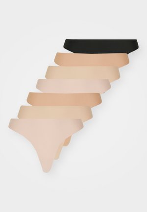 Ten pairs of thong underwear in varying shades of nude and one black. Each features a smooth, seamless design with varying waistband heights.