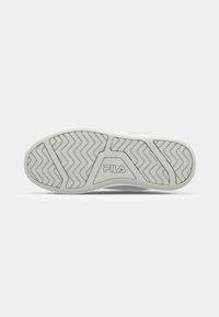 White rubber shoe sole with zigzag tread pattern and FILA logo. Smooth texture and rounded edges. Lightweight and flexible design.
