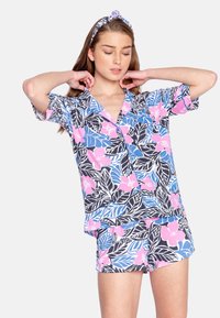 Kortärmad pyjamas-set med blommönster i rosa, blått och svart, tillverkat i mjukt material med en avslappnad passform och matchande huvudband.