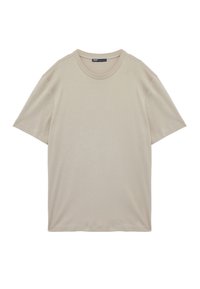 Camisa de manga corta beige hecha de suave algodón, con un escote redondo y un diseño simple, sin adornos, de corte regular.