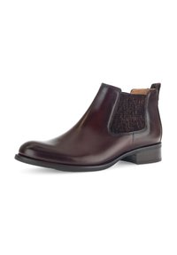Botín de cuero marrón con paneles laterales elásticos, diseño elegante, punta redondeada y tacón bajo. Textura suave con un sutil brillo y sin acentos visibles.