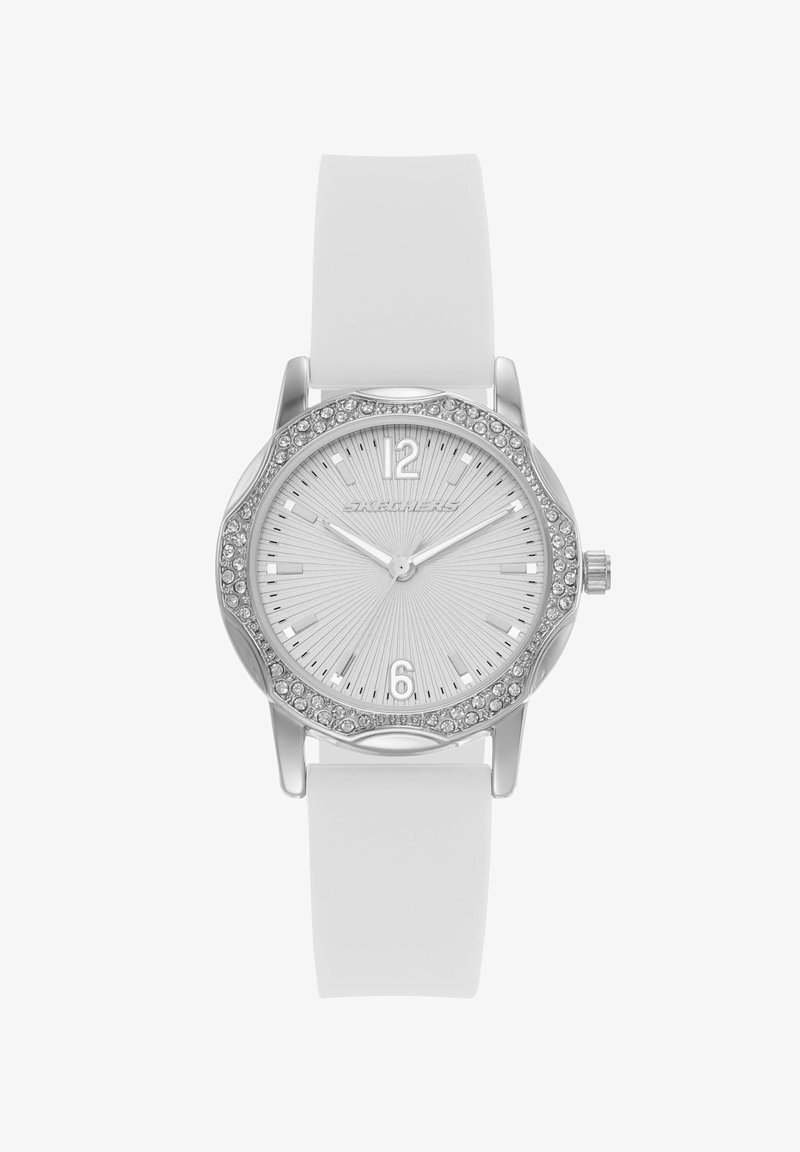 Montre blanche avec lunette argentée ornée de cristaux, cadran argenté à motif rayonnant, et bracelet en silicone blanc affichant 10h09.