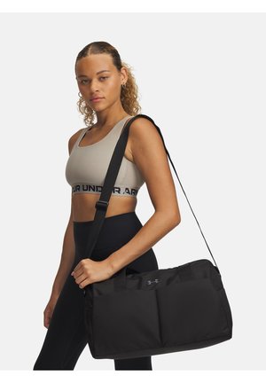 Black duffel bag with dual top handles and a detachable shoulder strap, featuring a smooth texture and prominent logo on the front.