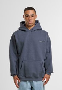 Hooded sweatshirt in dark gray cotton blend, featuring a front pocket, ribbed cuffs, and a small white logo on the chest.