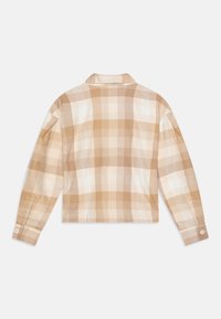 Beige en crème geruit overhemd met lange mouwen, een rechte pasvorm, knoopmanchetten en een klassieke kraag. Zachte stof met een ruitpatroon.