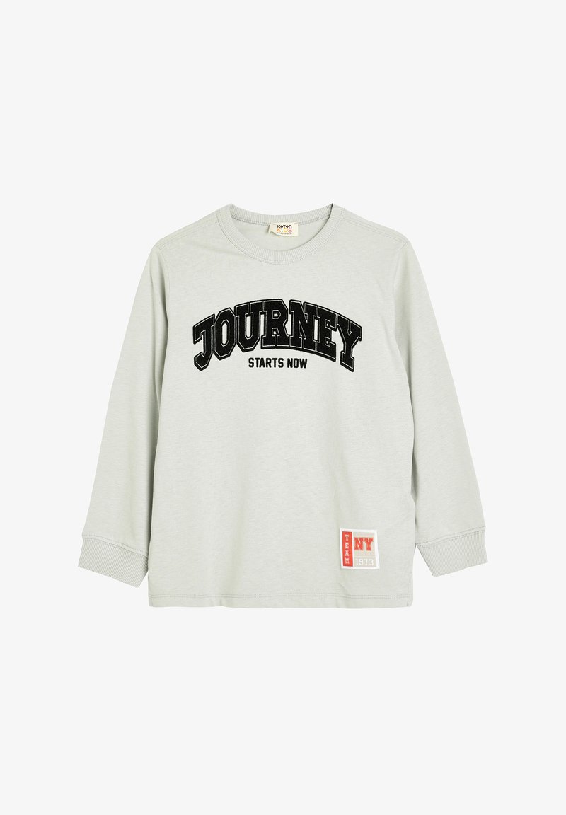 Light grey long-sleeve shirt featuring a black "JOURNEY STARTS NOW" graphic. Includes a red and white "TEAM NY 1973" patch on the hem.