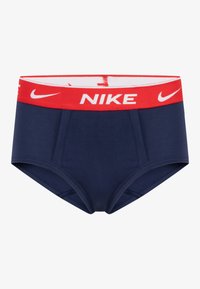Námornícke boxerky s elastickým pásom v červenej a bielej farbe s logom "NIKE". Hladká textúra a priliehavý strih, vhodné na športové nosenie.