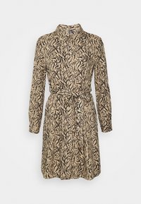 Skjortklänning i beige med svart abstrakt mönster, lång ärm, krage och resårdetalj i midjan. Mjuk tyg med avslappnad passform.