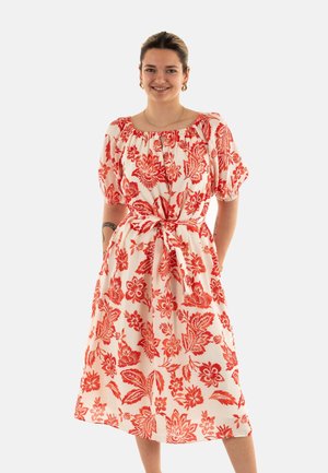 Floral-print midi dress in cream with red flowers, puff sleeves, and a gathered neckline. Tied waist accentuates the silhouette.