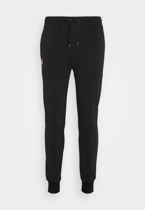 Pantaloni sportivi neri realizzati in tessuto misto cotone, con vita regolabile tramite laccetto, gambe affusolate, polsini a costine e un piccolo logo sulla coscia sinistra.
