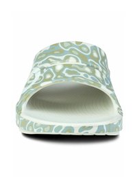 Atvērtā pirksta slaidi ar viļņveida zaļo un balto rakstu, ar strukturētu iekšējo daļu un elastīgu zoli. Apakšdaļa nedaudz izliekta uz augšu.