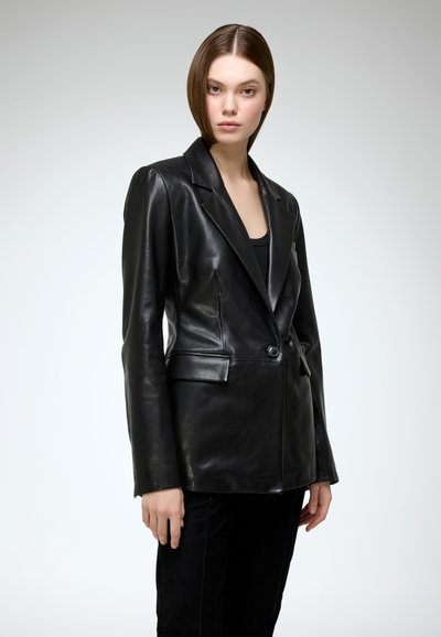 Black leather blazer with a tailored fit, notched lapels, single button closure, and front pockets. Smooth texture and structured design.