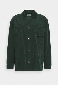 Grön manchesterjacka med krage, framknappar, två bröstfickor och en broderad logotyp på vänster sida. Strukturerad tyg.