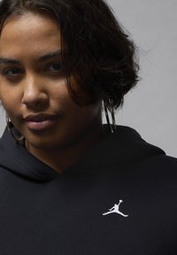 Felpa nera con cappuccio caratterizzata da un grande logo Jumpman ricamato in bianco. Tessuto morbido con una superficie liscia e un design a vestibilità rilassata.