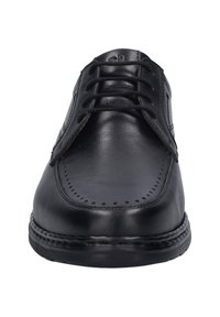 Scarpa eleganti in pelle nera con punta tondeggiante, dettagli perforati, allacciatura frontale e suola robusta. Texture liscia, design classico.