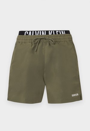 Męskie spodenki kąpielowe w oliwkowej zieleni z elastycznym pasem i sznurkiem, czarny wewnętrzny pas z białym logo Calvin Klein, boczne kieszenie.