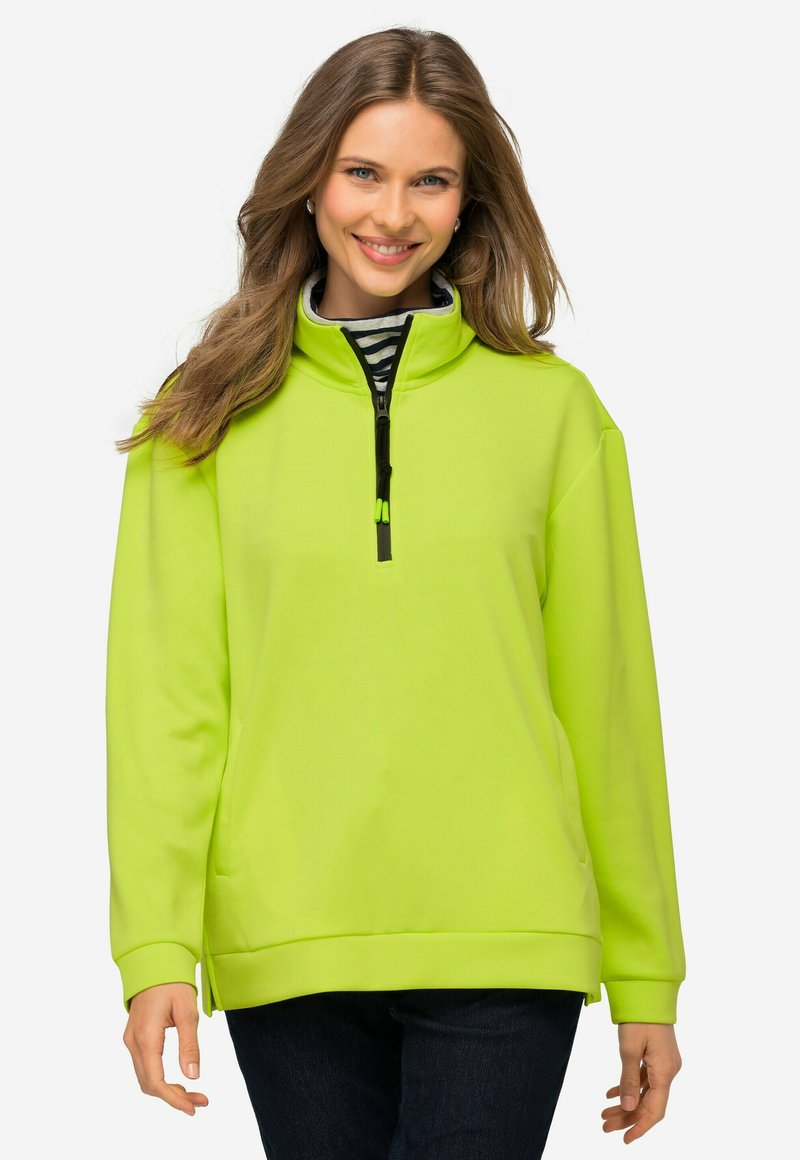 Pulóver verde neón con cuello de media cremallera, que cuenta con mangas largas y un corte relajado. Suave textura y bolsillos laterales mejoran la funcionalidad.