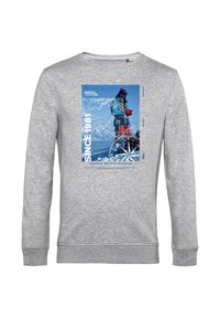 Felpa grigia con maniche lunghe e scollo rotondo. Sul davanti presenta una grafica blu con un alpinista e una bussola.