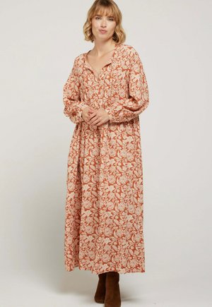 Robe longue à motifs en orange rouillé avec un design floral blanc. Dotée d'un décolleté en V, de manches ballon et d'une taille froncée. Texture de tissu douce.