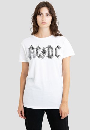 White cotton t-shirt featuring a black AC/DC graphic with ornate lettering and a lightning bolt. Short sleeves and a standard fit.