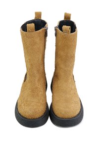 Botas de tobillo de ante en color marrón claro con una superficie texturizada, cremalleras laterales y suelas en negro contrastante. Presentan pequeñas lengüetas de tirón en la parte superior.